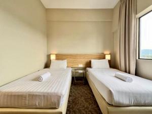 Postel nebo postele na pokoji v ubytování Kingston Hotel 10 - Bukit Jalil