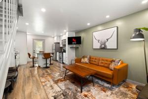 a living room with a couch and a table at Spectacular Austin SoCo Townhome in Austin