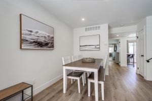 a white dining room with a table and chairs at Pristine in Pacific Beach One Block to the Ocean in San Diego
