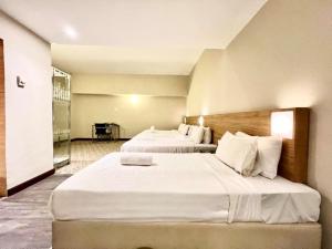 Postel nebo postele na pokoji v ubytování Kingston Hotel 10 - Bukit Jalil