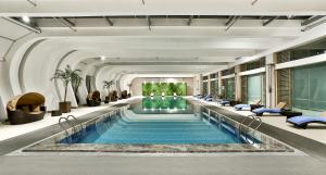 a large swimming pool in a hotel lobby at Holiday Inn Express Chengdu Wenjiang Hotspring by IHG in Chengdu