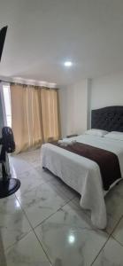 a bedroom with two beds in a room at Apartahotel Rubí San Gil in San Gil