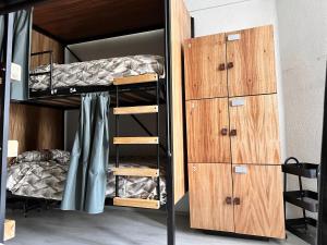 a bunk room with a bunk bed and a dresser at Wanderlust District in Mexico City +6 photos