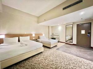 Postel nebo postele na pokoji v ubytování Kingston Hotel 10 - Bukit Jalil