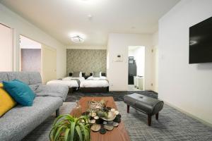 a living room with a couch and a table at MP STYLE SAPPORO-35 in Minami-jūichijō +51 photos