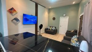 a living room with a glass table and a tv at Cerca de todo en La Union in La Unión