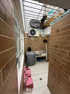 a room with two pink chairs in a brick wall at Casa calima in Cali +28 photos