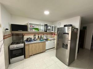 a kitchen with a stainless steel refrigerator and appliances at Casa calima in Cali