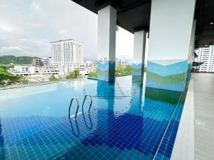 a pool on the roof of a building at AFFT Home Camp - Kota Kinabalu Seaview in Kota Kinabalu