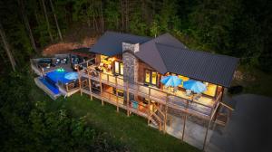 an aerial view of a house with umbrellas at Honey Bear Hideaways - Luxury Cabin with Infinity Pool, Breathtaking Mountain Views & Sunset Decks in Sevierville