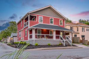 a red house with a gambrel at Indy Getaway - 5BR - Sleeps 16 - Arcade games - Perfect for families and groups in Indianapolis