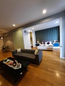 a living room with a couch and a bed at The Platinum KLCC by Dream Suites in Kuala Lumpur