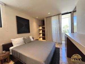 a bedroom with a bed and a large window at Peregrina Tulum 101A 2BR Luxury Condo in Tulum +54 photos