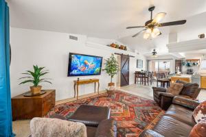 a living room with a couch and a table at Lake View, Themed Rooms, King Beds, Fire Pit in Lake Havasu City