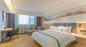 Postel nebo postele na pokoji v ubytování GreenTree Inn Bozhou Weiwu Road Hotel + 155 fotografií