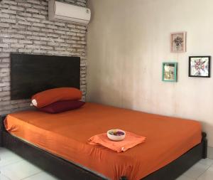 Postel nebo postele na pokoji v ubytování kunci rumah