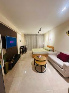 a living room with a couch and a table at Unique Studio Free access beach in Hurghada