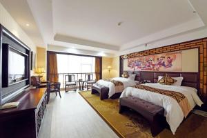 a hotel room with two beds and a flat screen tv at Wanjiale International Hotel in Changsha +143 photos