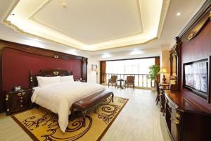 a bedroom with a large bed and a television at Wanjiale International Hotel in Changsha