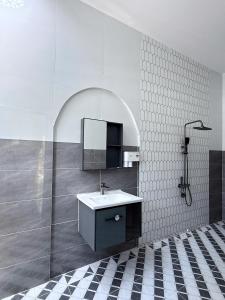 a bathroom with a sink and a mirror at Suri Homestay Mũi Né in Mui Ne