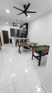a living room with a table and ping pong ball at Stay Put by Liza in Jasin
