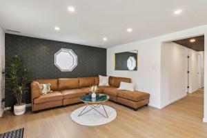 a living room with a couch and a table at Charming 3-Bedroom - Hot Tub & Game Room in Vermilion
