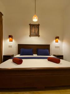 a bedroom with a bed with two pillows on it at Oasis Bay - Arugam Bay in Arugam Bay