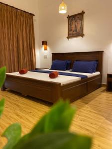 a bedroom with two beds with blue pillows at Oasis Bay - Arugam Bay in Arugam Bay