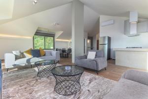 a living room with a couch and a table at 2BR Sunset Over Ain Saade in Beit Meri