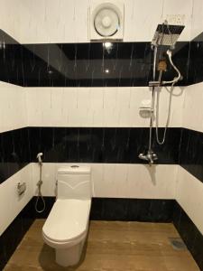 a bathroom with a toilet and a shower at Oasis Bay - Arugam Bay in Arugam Bay