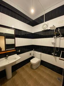 a bathroom with a toilet and a sink at Oasis Bay - Arugam Bay in Arugam Bay
