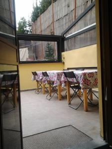 a table and chairs sitting on a patio at Emerald Fields Hostel in Florence