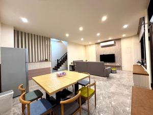 a living room with a wooden table and chairs at Travel Happiness Homestay in Huxi +28 photos