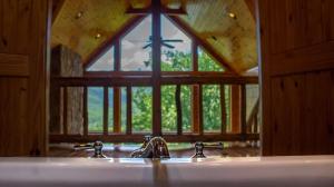 a bathroom mirror with a sink and a window at Majestic Manor - Peaceful Modern Cabin Retreat Near Watauga Lake in Butler +44 photos