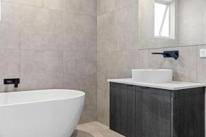 a bathroom with a tub and a sink and a bath tub at The Sanctuary in Rosebud +24 photos
