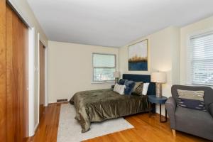 a bedroom with a bed and a chair at The Cincinnati Charm in Cincinnati