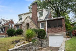 a brick house with a white garage at The Cincinnati Charm in Cincinnati +34 photos