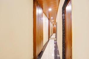 a hallway with wooden ceilings and a long corridor at Via Surya Grand in Mumbai
