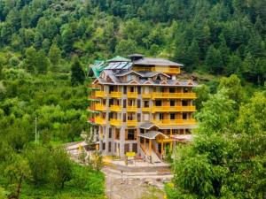 a large building in the middle of a forest at The Hosteller Old Manali, Manu Temple in Manāli