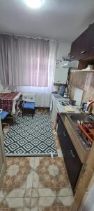 a kitchen with a sink and a counter top at Apartament 2 camere R4 in Siret