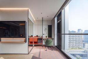 an apartment kitchen with a desk and a large window at EVEN Hotel Shanghai Jinqiao by IHG in Shanghai