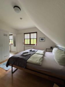a bedroom with a large bed in a attic at Ostwind - ferienwohnungen & meer in Steffenshagen