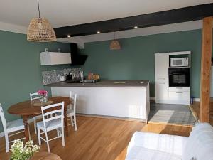 een keuken en een woonkamer met een tafel en een aanrecht bij Hébergement quartier historique in Parthenay