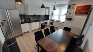 a kitchen with a table and chairs and a refrigerator at Florence 4 Bedroom house, sleeps 14 in Killingbeck