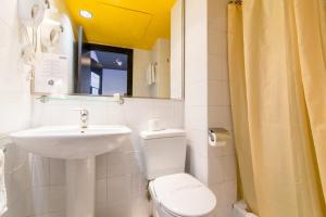 a bathroom with a sink and a toilet and a mirror at Colors in Barcelona