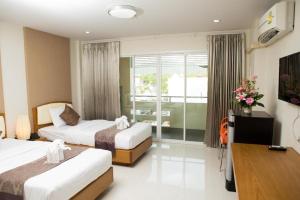 a hotel room with two beds and a balcony at TK Mansion in Ban Kohong +34 photos