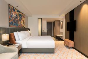 a hotel room with a bed and a couch at Crowne Plaza Lucknow by IHG in Lucknow