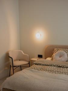 a bedroom with a bed and a chair and a lamp at Babiogórska Stodoła in Zawoja +32 photos