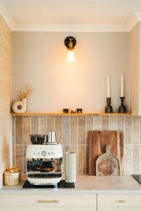 a kitchen with a toaster oven on a counter at The Woodshed - Hot Stone Sauna & Ice Bath in Robe
