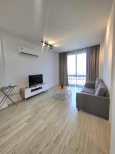 a living room with a couch and a television at Zen66 @ Roxy Serviced Apartment in Kuching